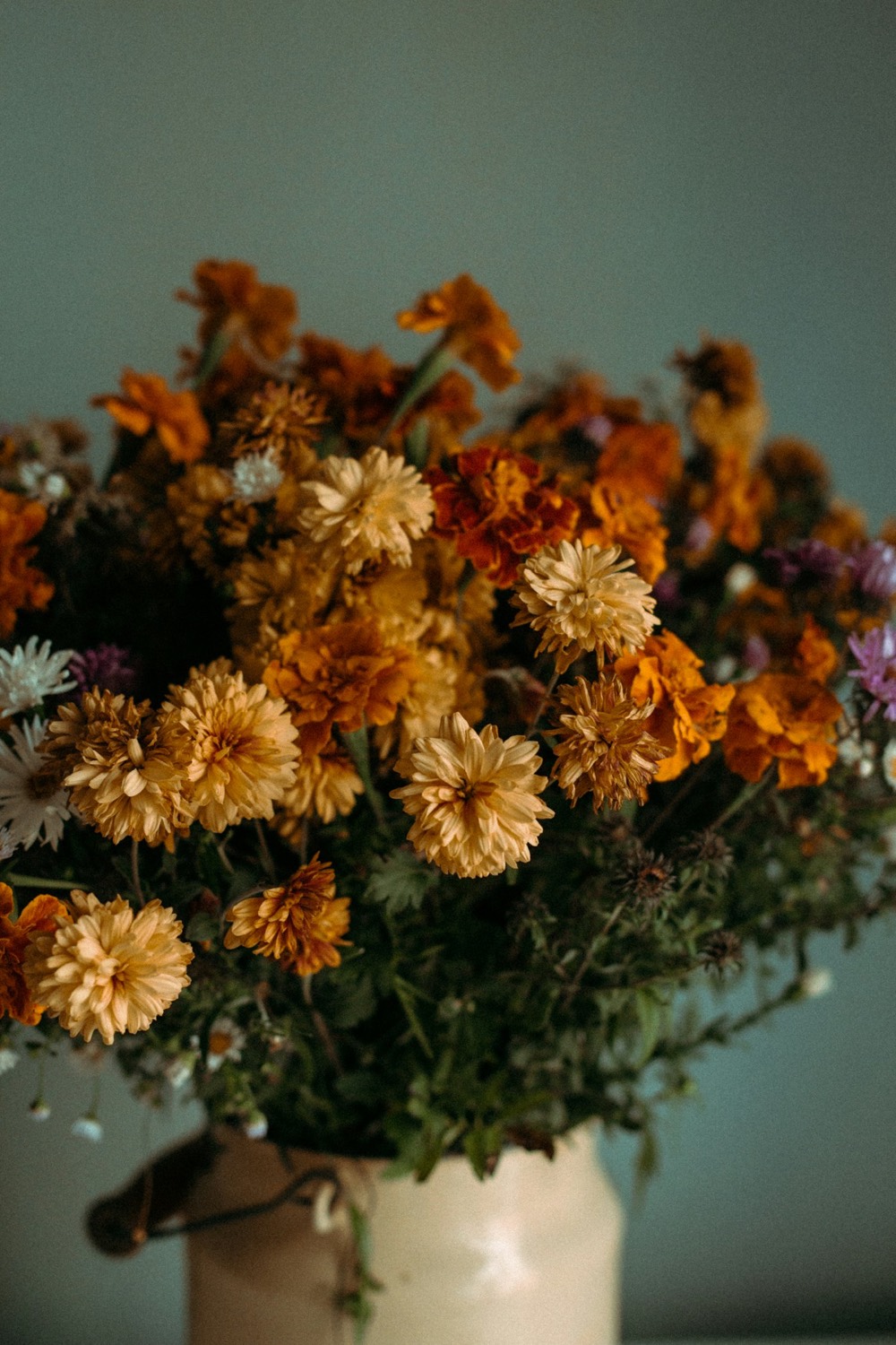 Arrangement of orange and gold dried flowers