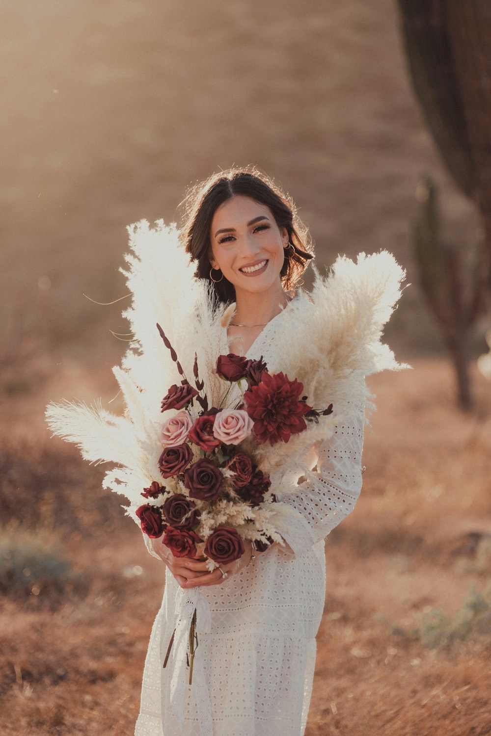 Bride holding a pampas and burgundy bouquet