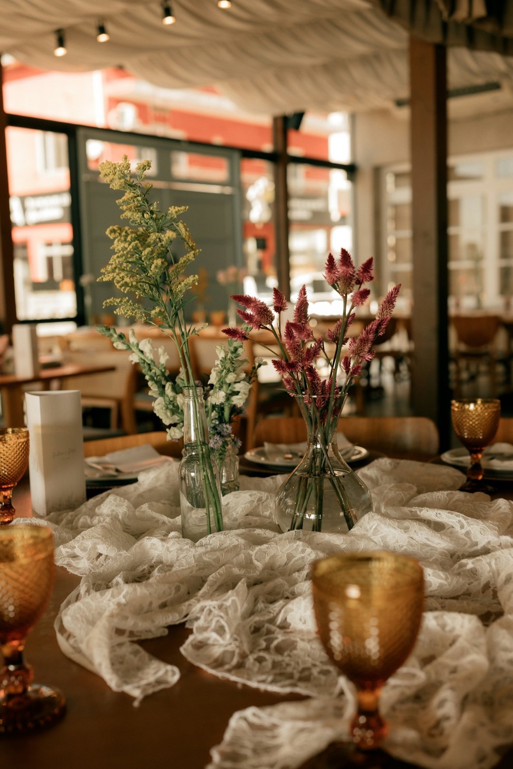 Reception tables glowing with candles and dried florals