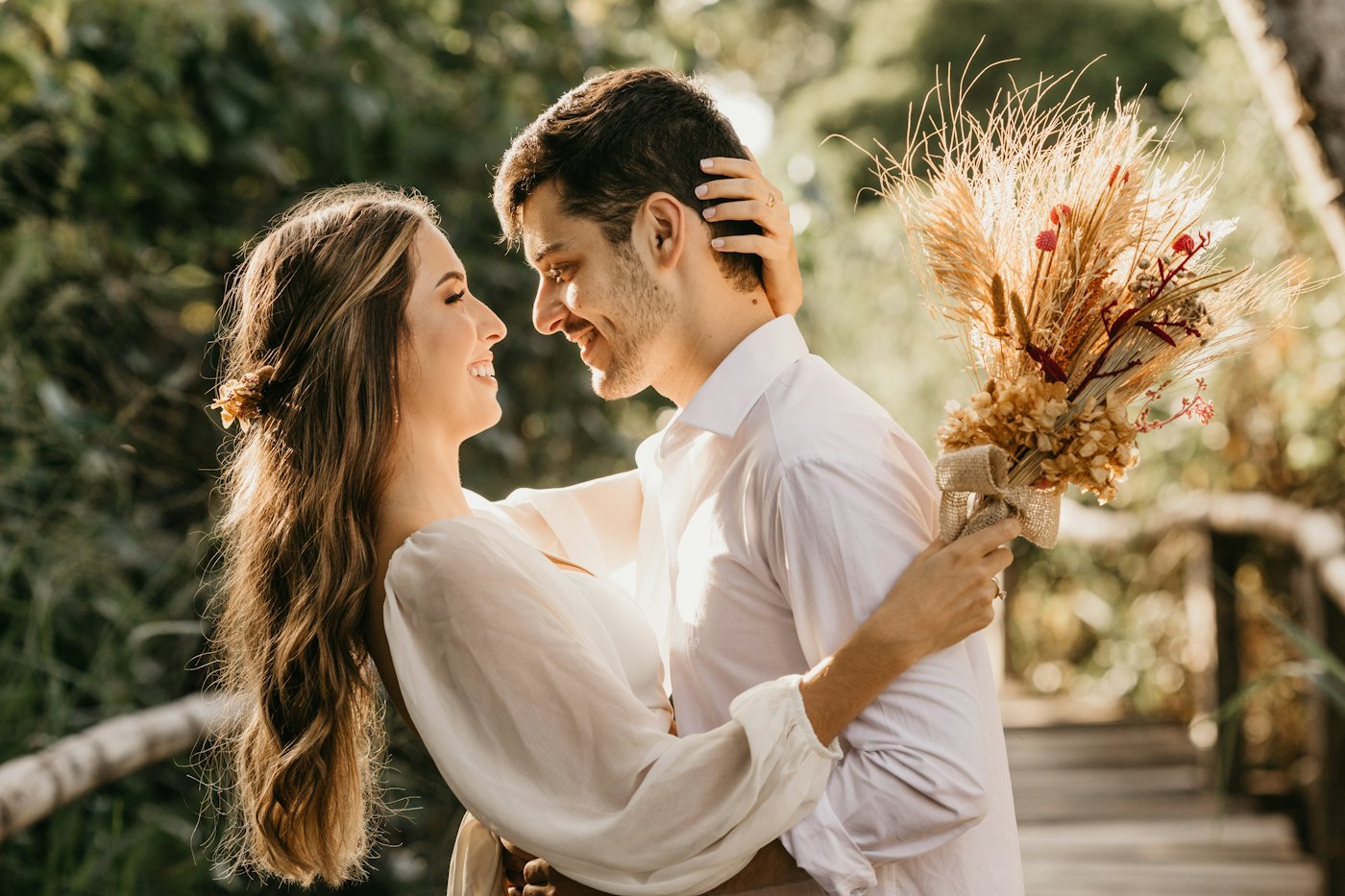 Couple embracing beside pampas grass
