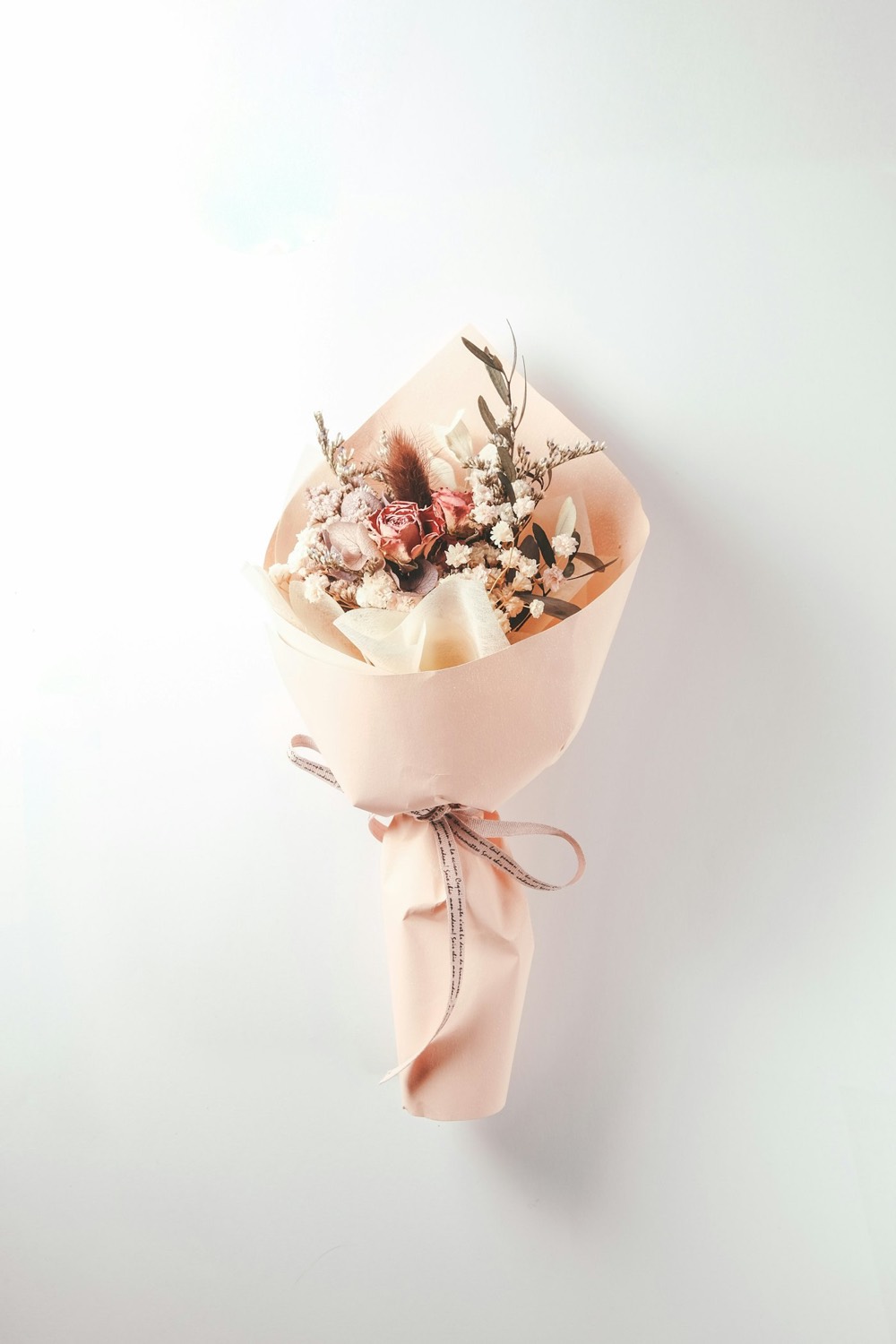 Dried flower bouquet wrapped in blush paper