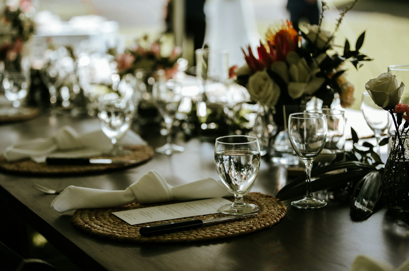 Glassware and place settings on a dark table