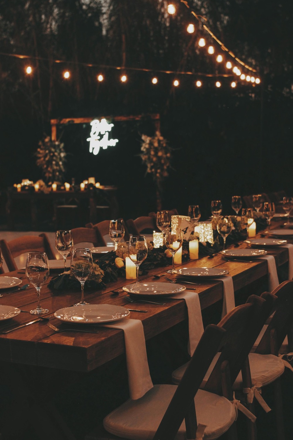 Reception tables under string lights at night