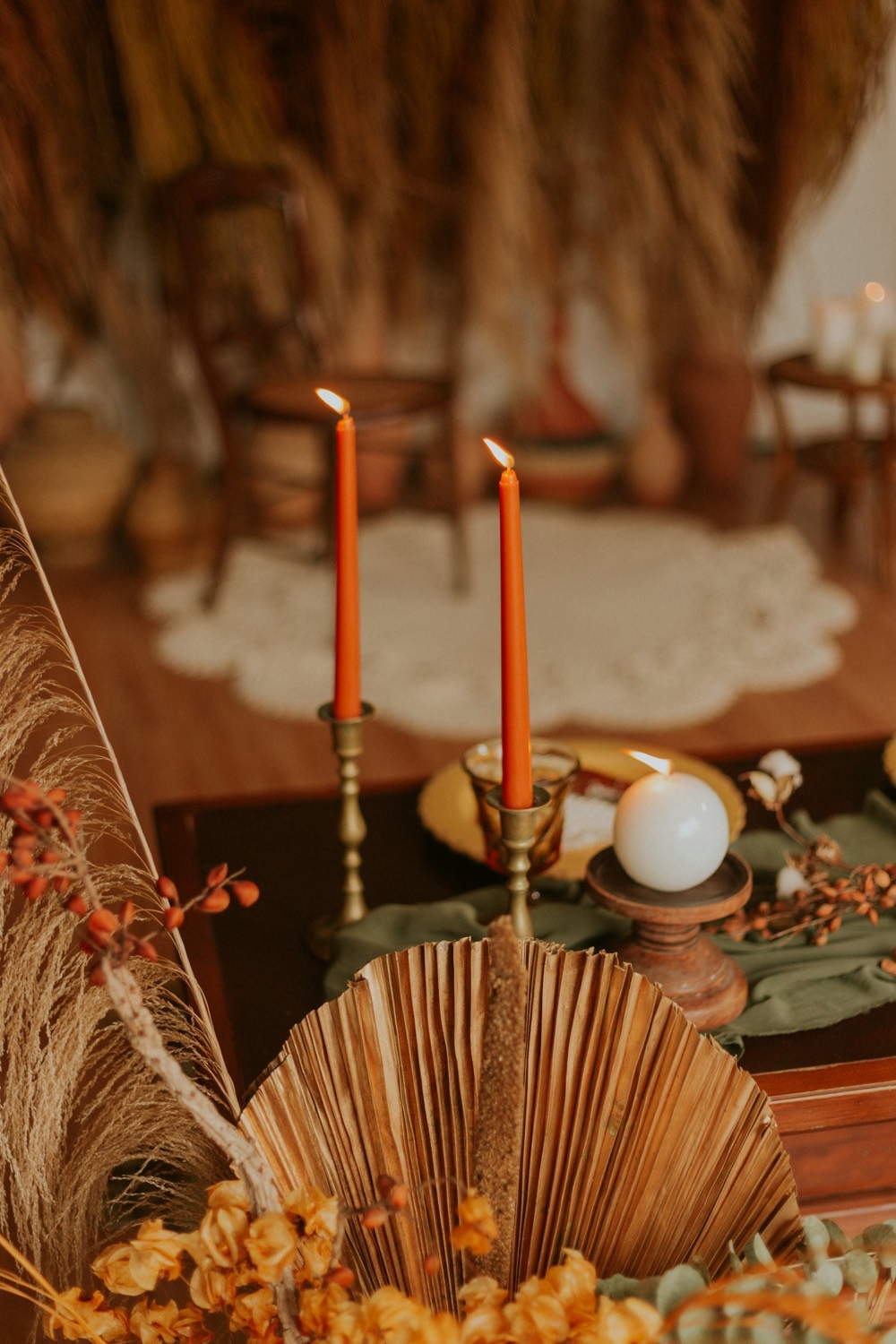 Terracotta taper candles in brass holders